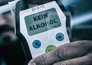 Close Up of a Man’s Hand Holding a Breathalyzer.