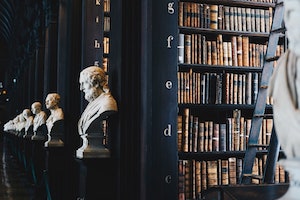 OC Criminal Attorney Angled View of a Law Library with Different Busts at the End of Each Bookshelf
